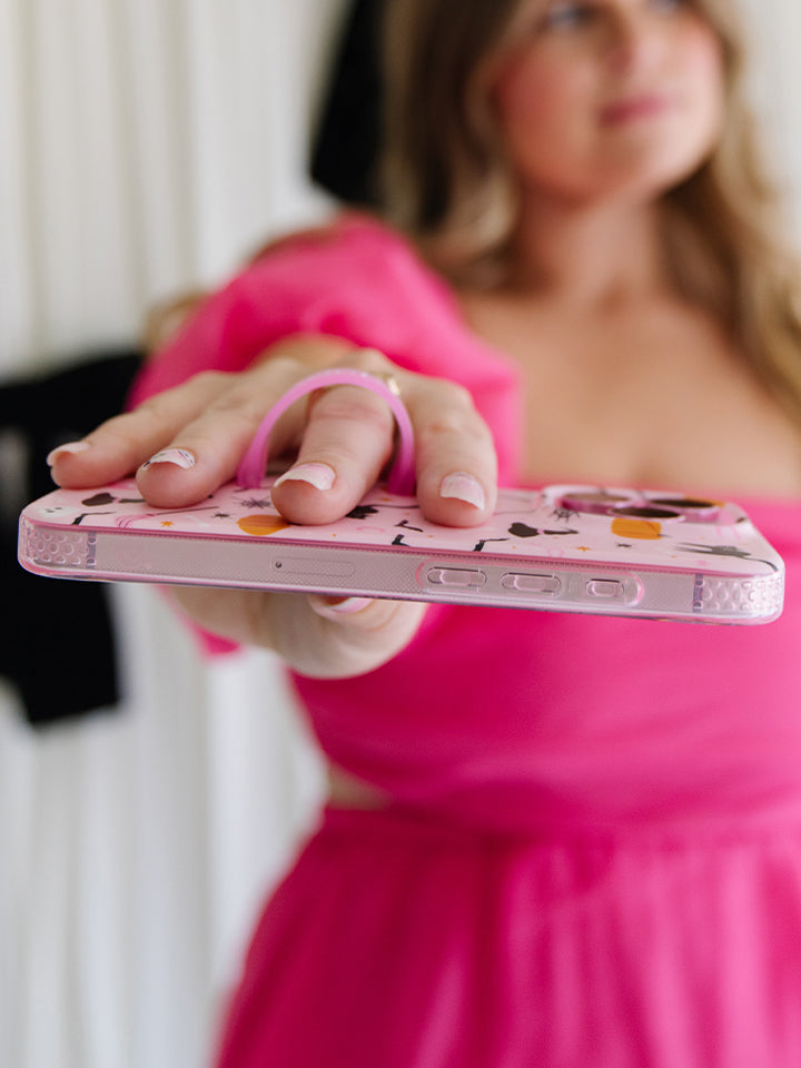 A woman holding a Witchy Wonder Loopy Case. || feature-media