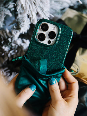 A woman holding an Emerald Sparkle Loopy Case.|| feature-media