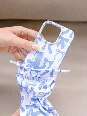A woman holding a Blue Bows Loopy Case. || feature-media