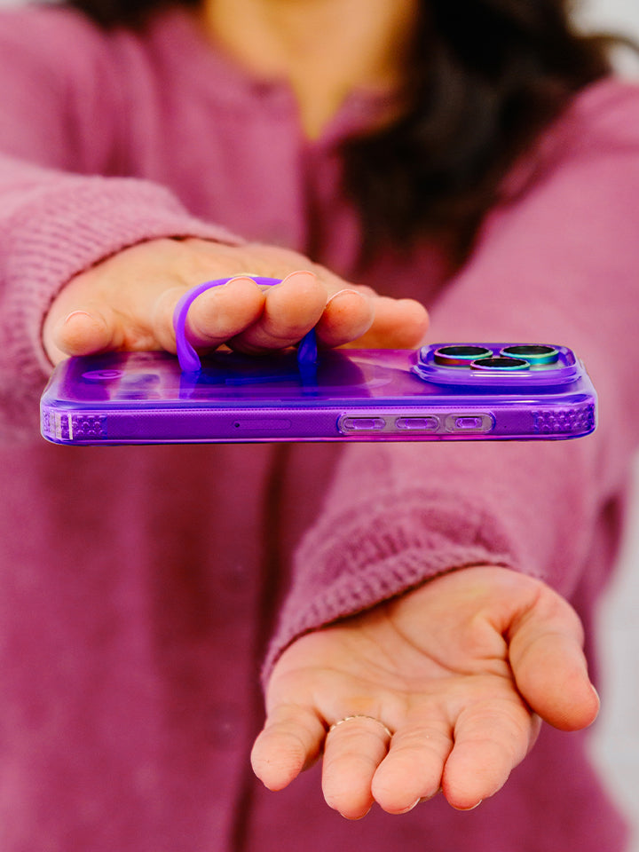 A woman holding a Clear Neon Purple Loopy Case. || feature-media
