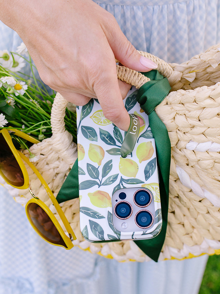 A woman holding a Lemon Grove Loopy Case. || feature-media
