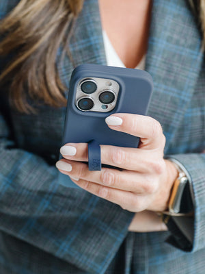 A woman holding a Denim Loopy Case. || feature-media