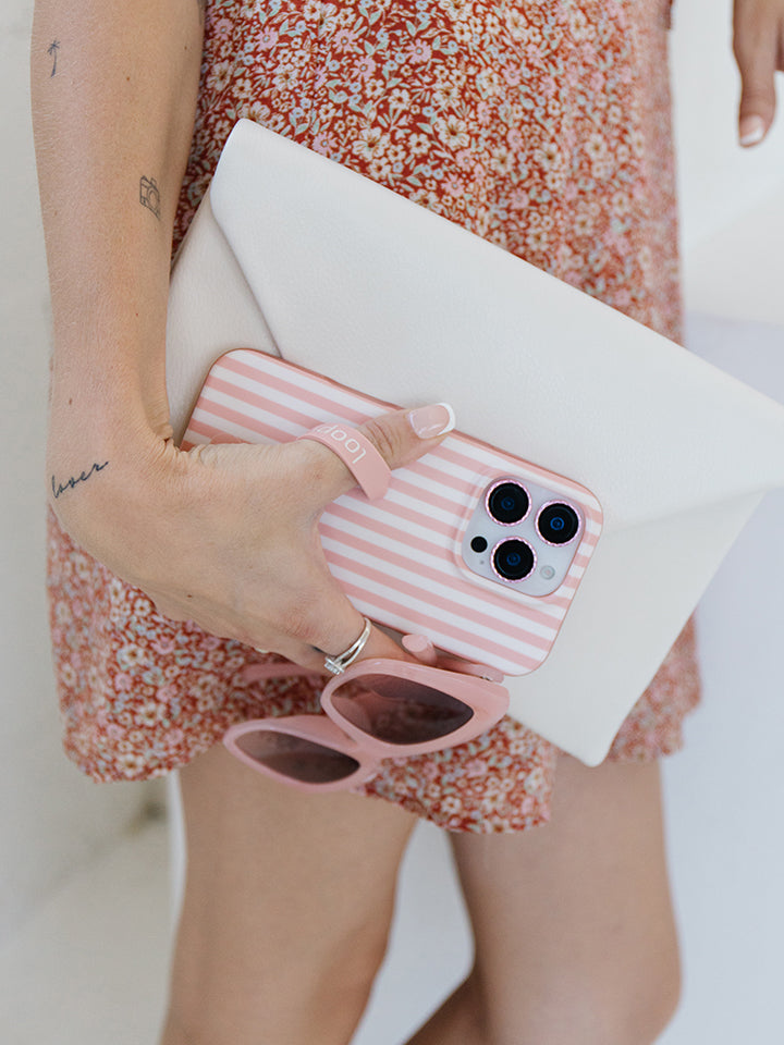 A woman holding a Terracotta Stripes Loopy Case. || feature-media