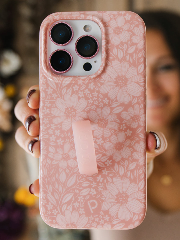A woman holding a Rosewood Meadow Loopy Case.  || feature-media