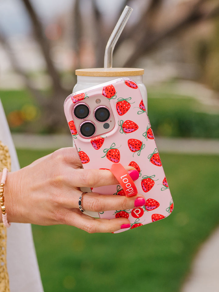 A woman holding a Berries and Bows Loopy Case. || feature-media