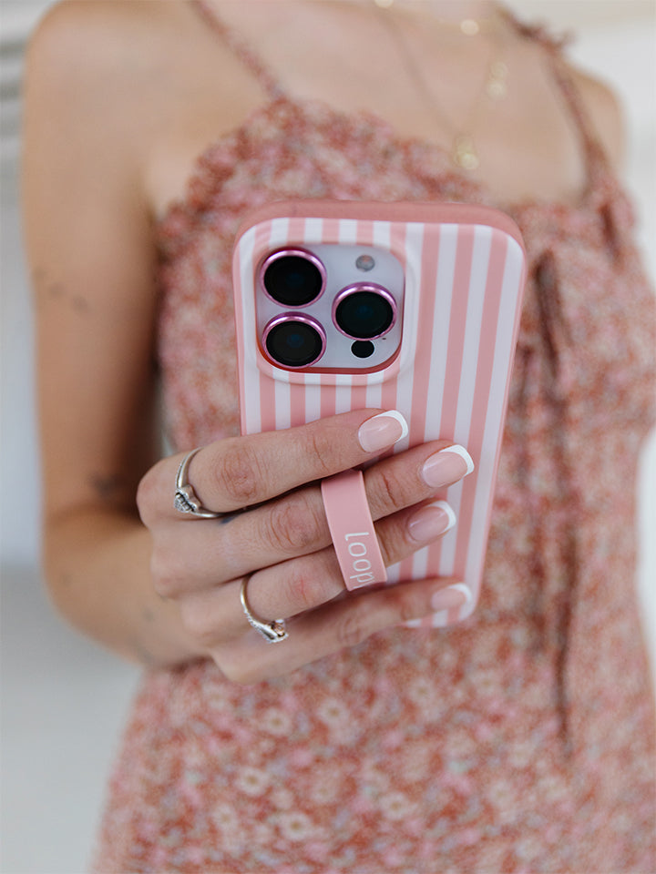 A woman holding a Terracotta Stripes Loopy Case. || feature-media