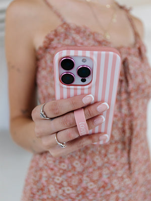 A woman holding a Terracotta Stripes Loopy Case. || feature-media