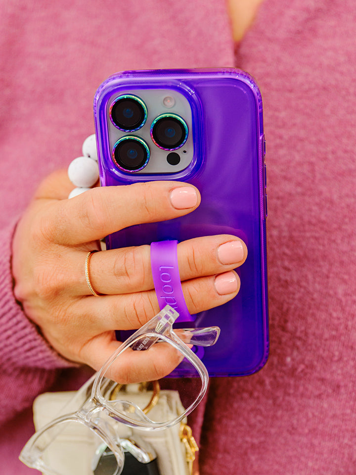 A woman holding a Clear Neon Purple Loopy Case. || feature-media
