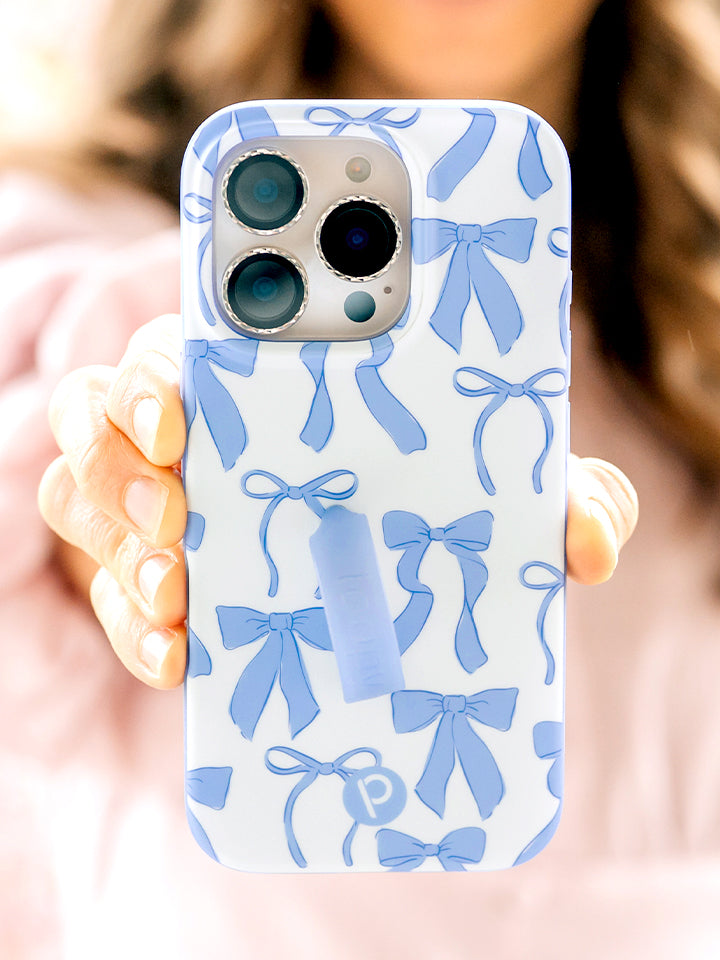 A woman holding a Blue Bows Loopy Case. || feature-media