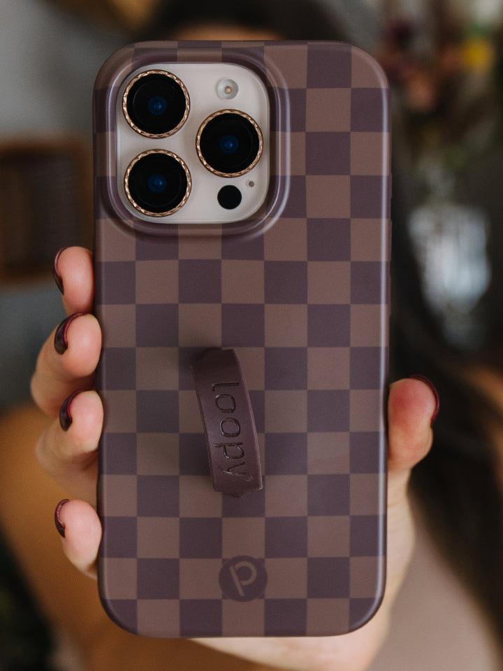 A woman holding a Cocoa Checkered Loopy Case. || feature-media
