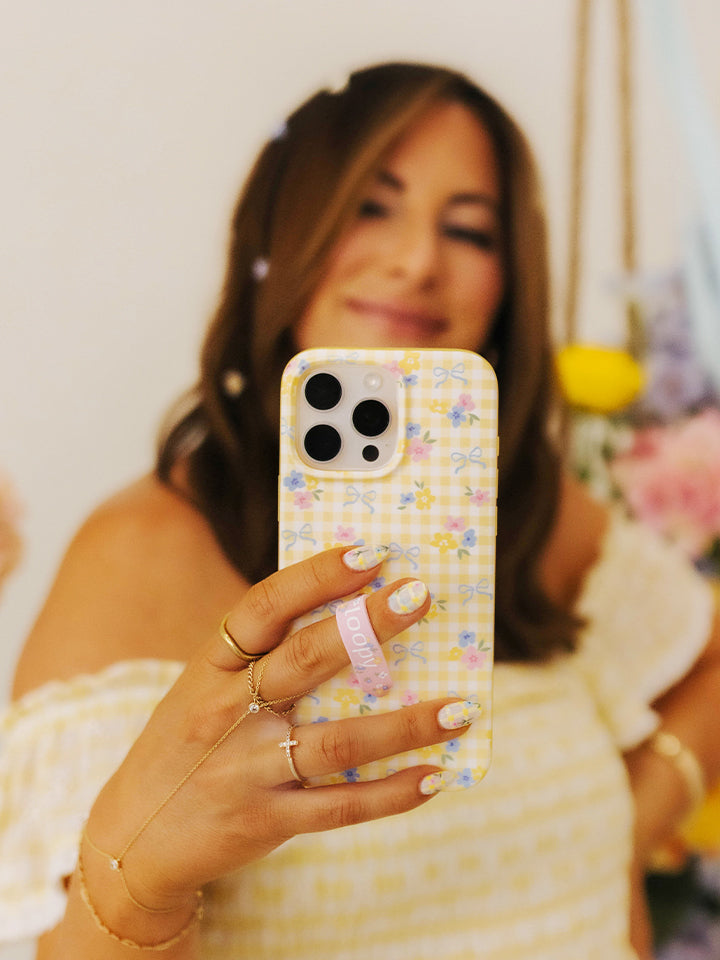 Krista Horton holding a Buttercup Blossom Loopy Case. 