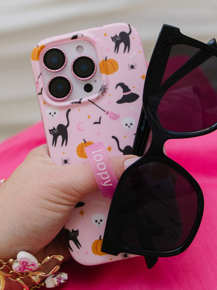 A woman holding a Witchy Wonder Loopy Case. || feature-media