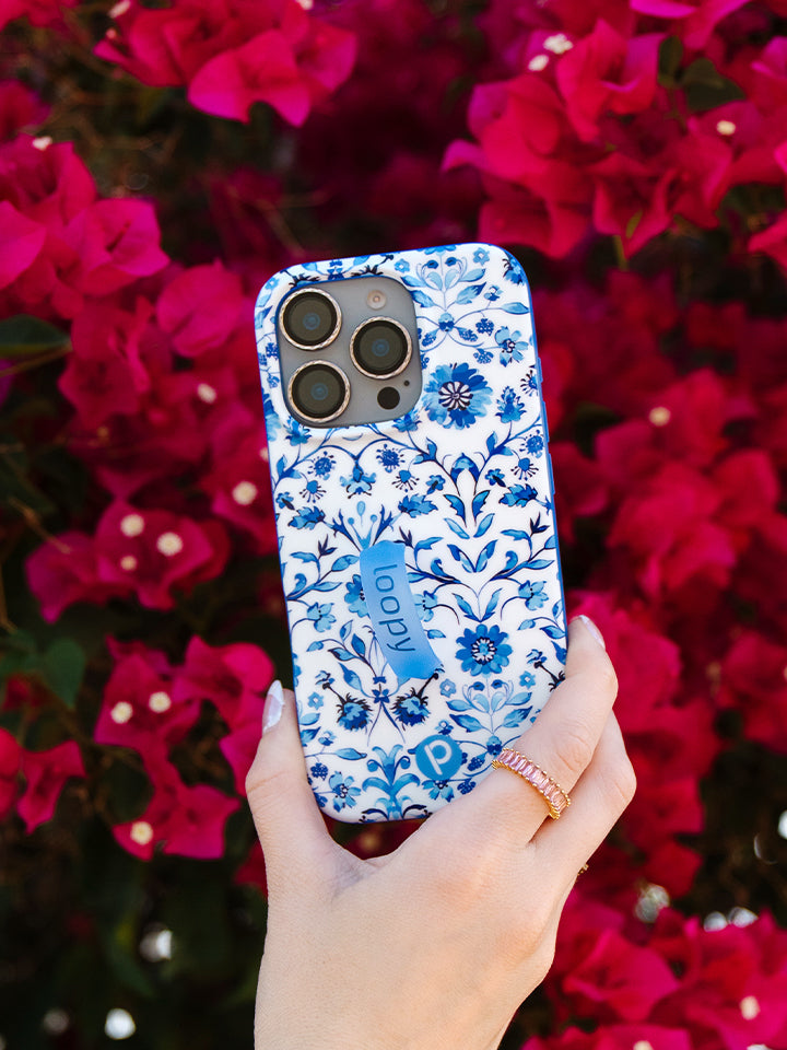 A woman holding a Blue Willow Loopy Case. || feature-media