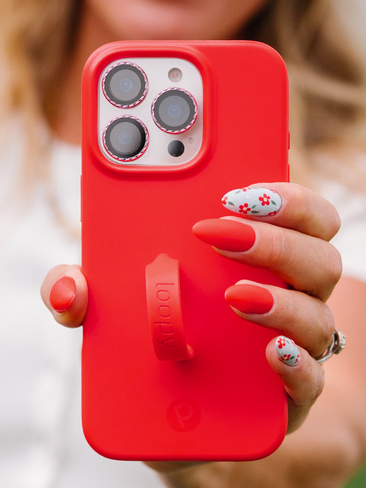 A woman holding a Red Loopy Case. || feature-media