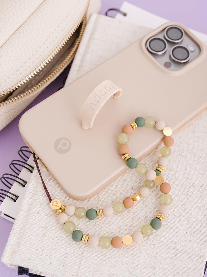 An Earthy Elegance Loopy Cases Wristlet attached to a Sandstone Loopy Case.