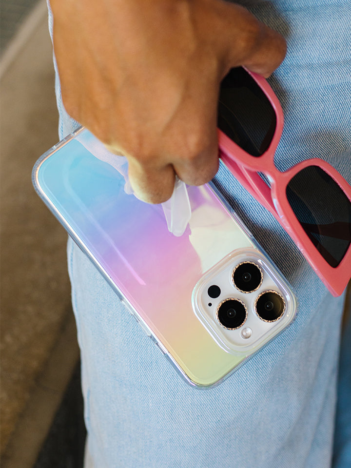 A woman holding a Clear Opal Loopy Case. 
