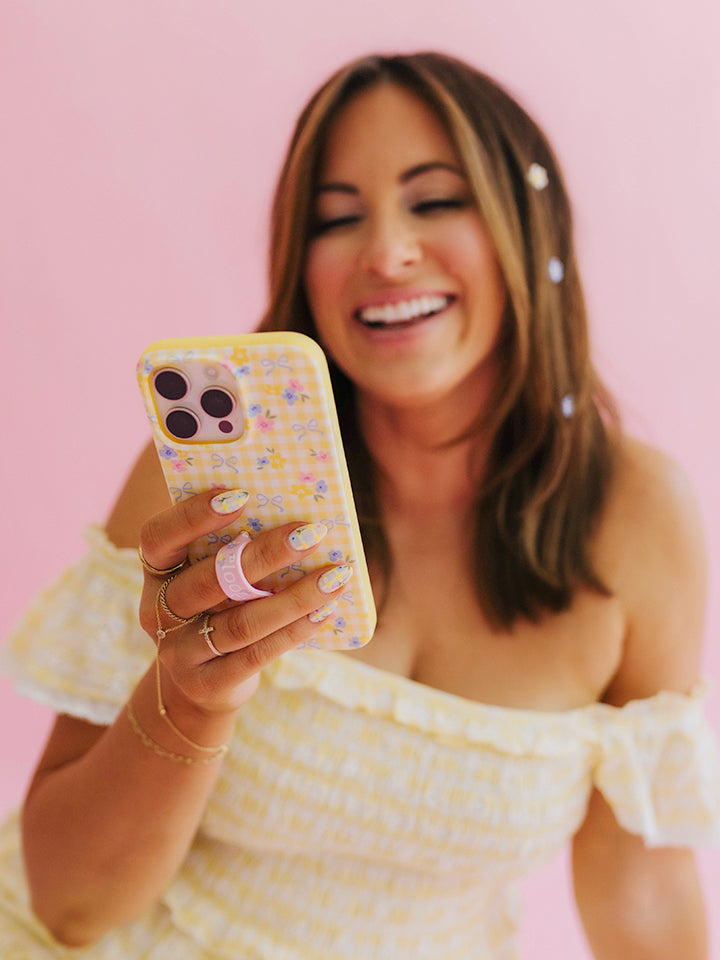 Krista Horton holding a Buttercup Blossom Loopy Case. || feature-media