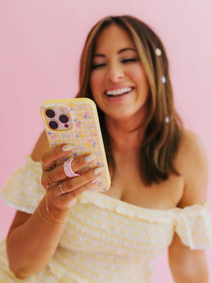 Krista Horton holding a Buttercup Blossom Loopy Case. || feature-media
