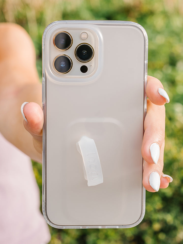 A woman holding a Matte Clear Loopy Case.|| feature-media
