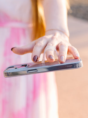 A woman holding a Platinum Sparkle Loopy Case. || feature-media