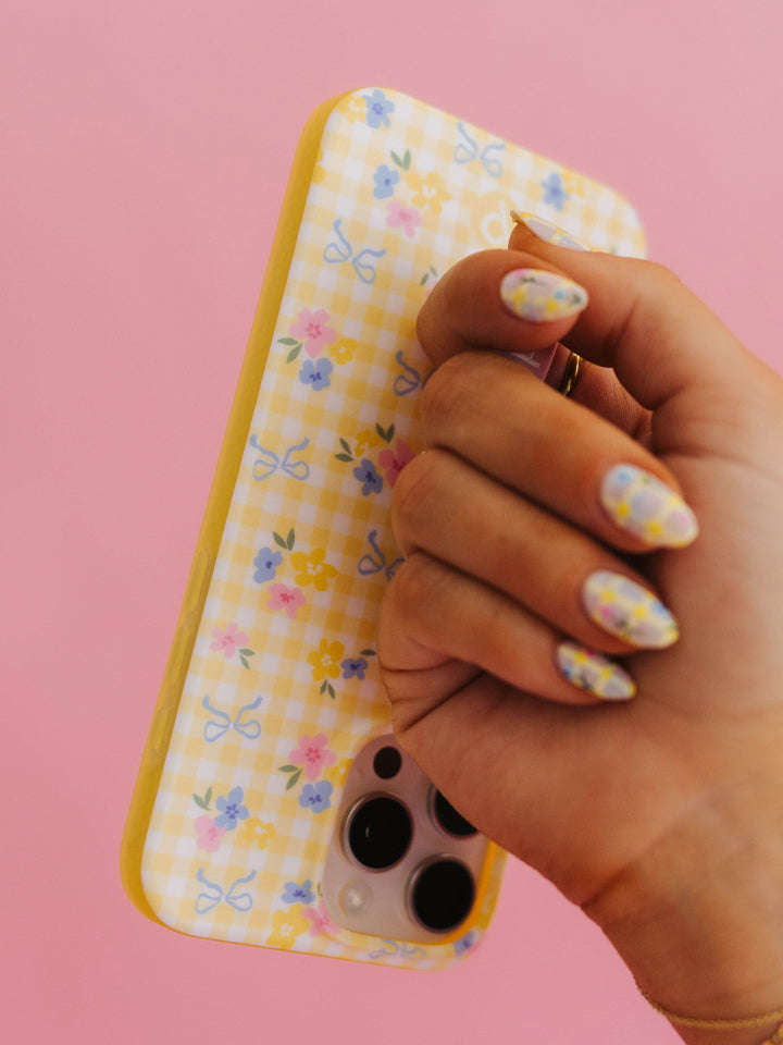 Krista Horton holding a Buttercup Blossom Loopy Case. || feature-media