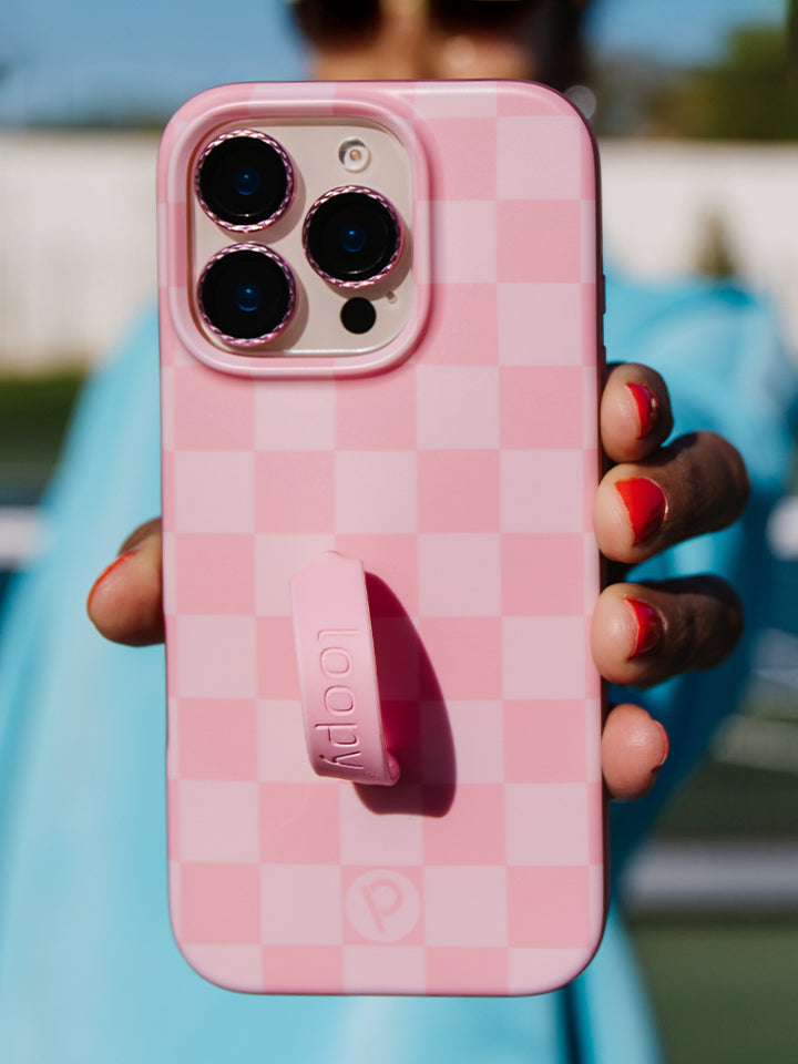 A woman holding a Blush Checkered Loopy Case. || feature-media