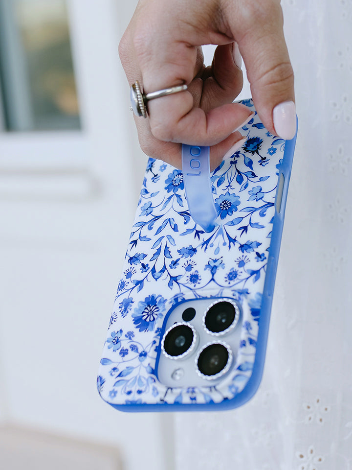 A woman holding a Blue Willow Loopy Case. || feature-media