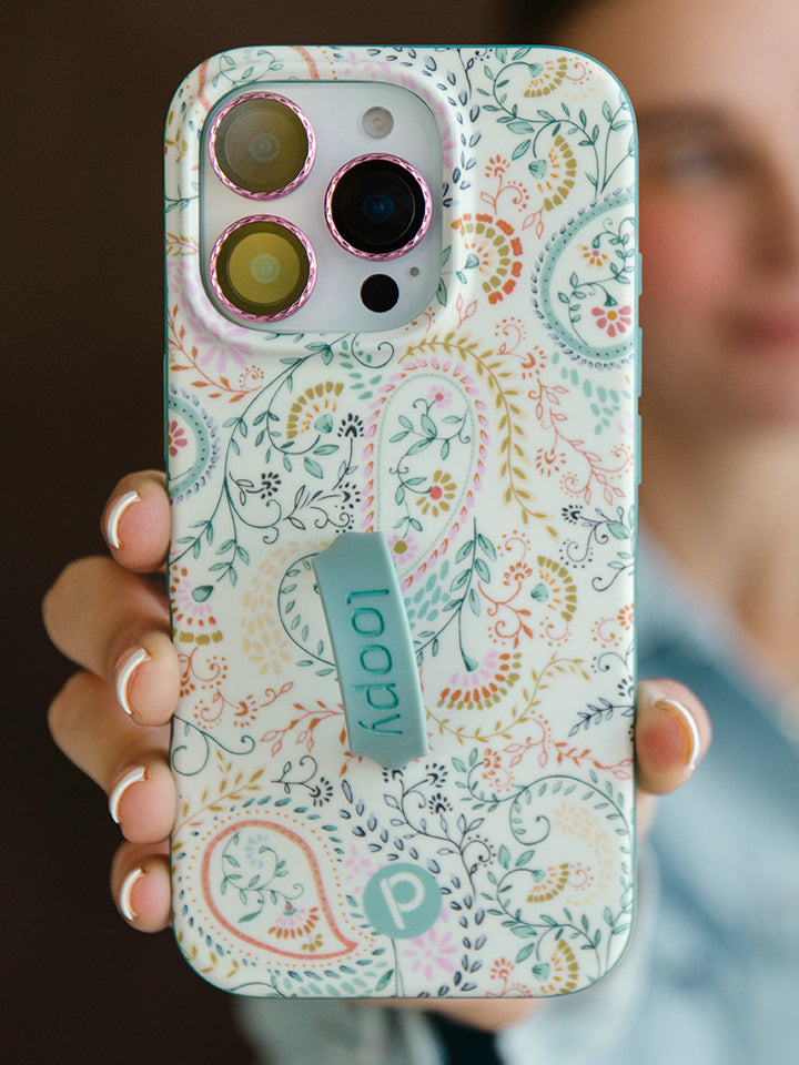 A woman holding a Painted Paisley Loopy Case. 