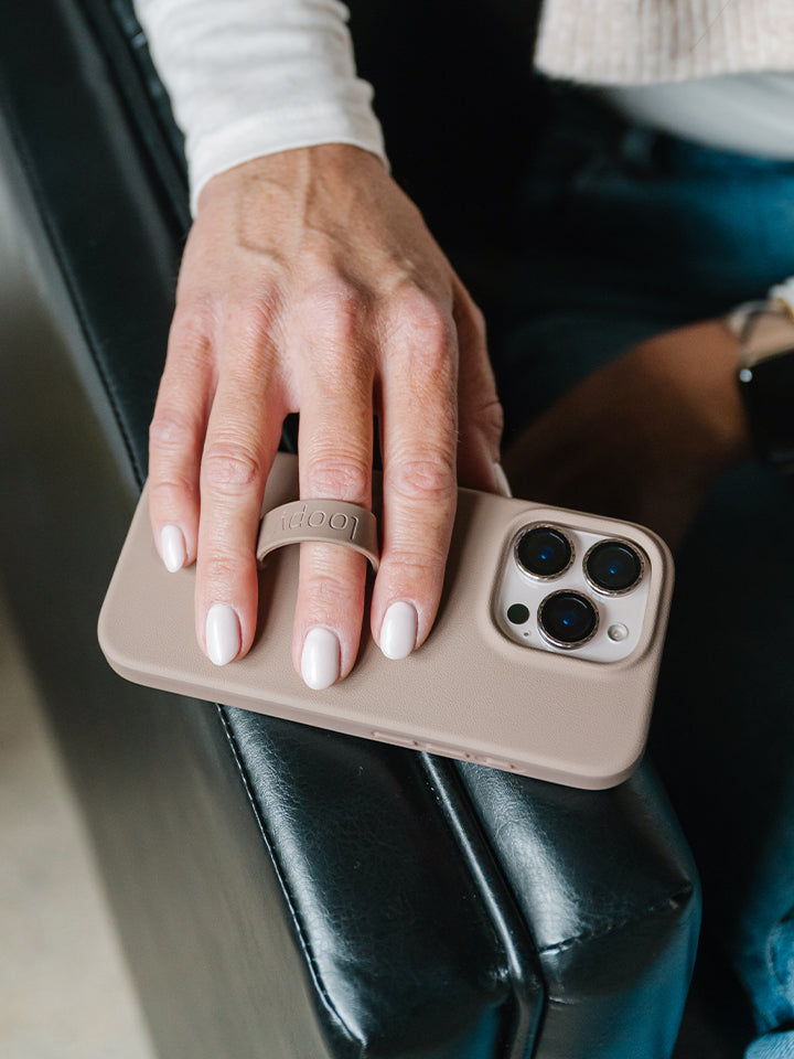 A woman holding a Stone Loopy Case. || feature-media