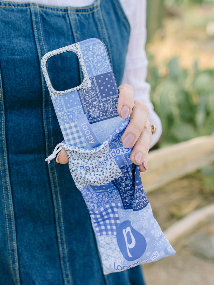 A woman holding a Bandana Blues Loopy Case. || feature-media