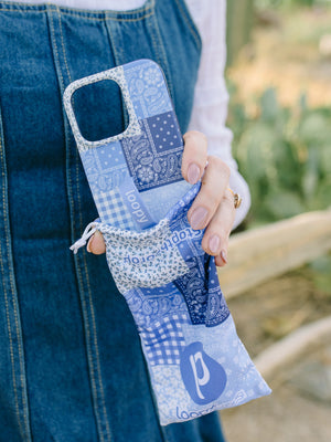 A woman holding a Bandana Blues Loopy Case. || feature-media