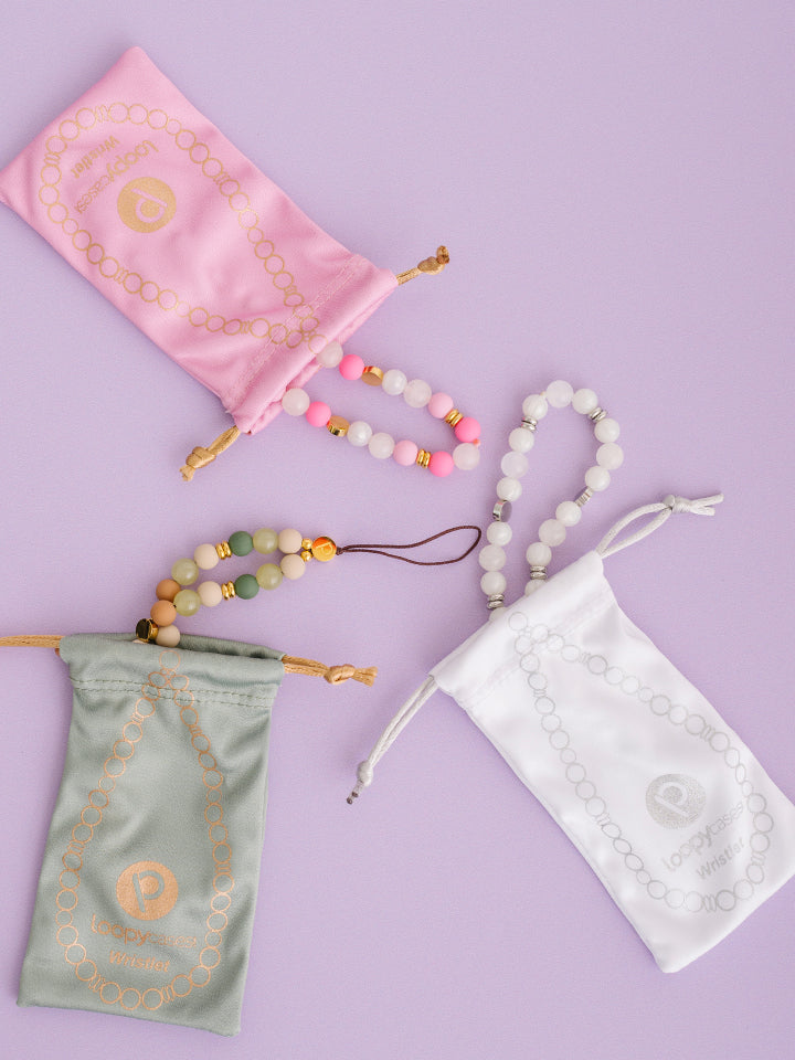 A Posh Pink, White Aura, and Earthy Elegance Loopy Cases Wristlet.