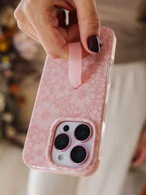 A woman holding a Rosewood Meadow Loopy Case.  || feature-media