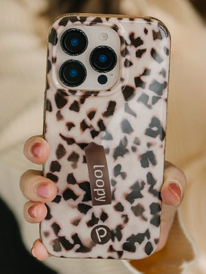 A woman holding a Blonde Tortoise Loopy Case. || feature-media