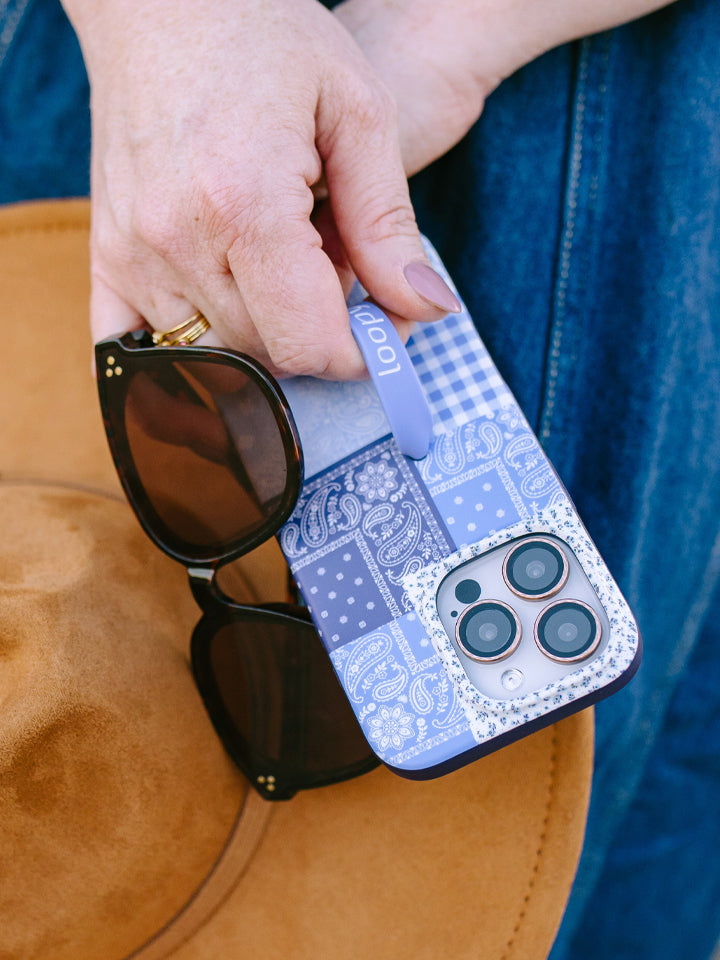 A woman holding a Bandana Blues Loopy Case. || feature-media