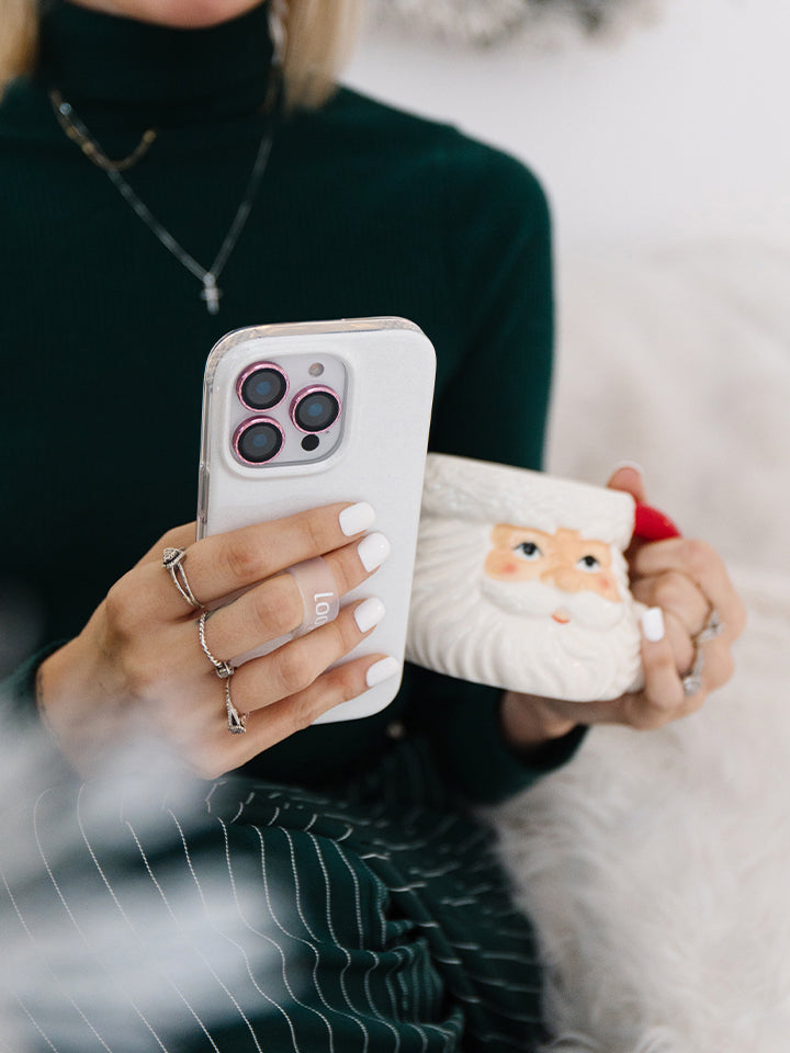 A woman holding a White Shimmer Loopy Case. || feature-media
