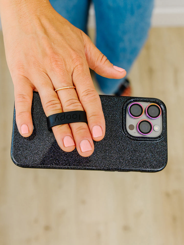 A woman holding a Sparkle Black Loopy Case.|| feature-media