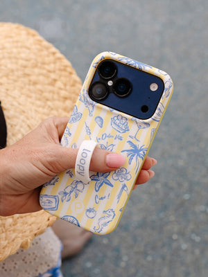 A woman holding a Limoncello Stripes Loopy Case. || feature-media
