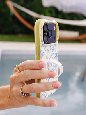 A woman holding a Limoncello Stripes Loopy Case. || feature-media