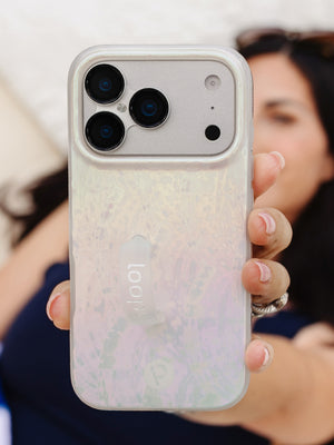 A woman holding a Sunkissed Shores Loopy Case. || feature-media