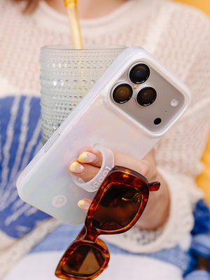 A woman holding a Sunkissed Shores Loopy Case. || feature-media