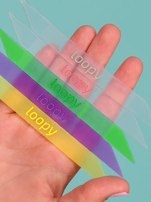 A woman holding five of the Loopy Cases Translucent Loops.