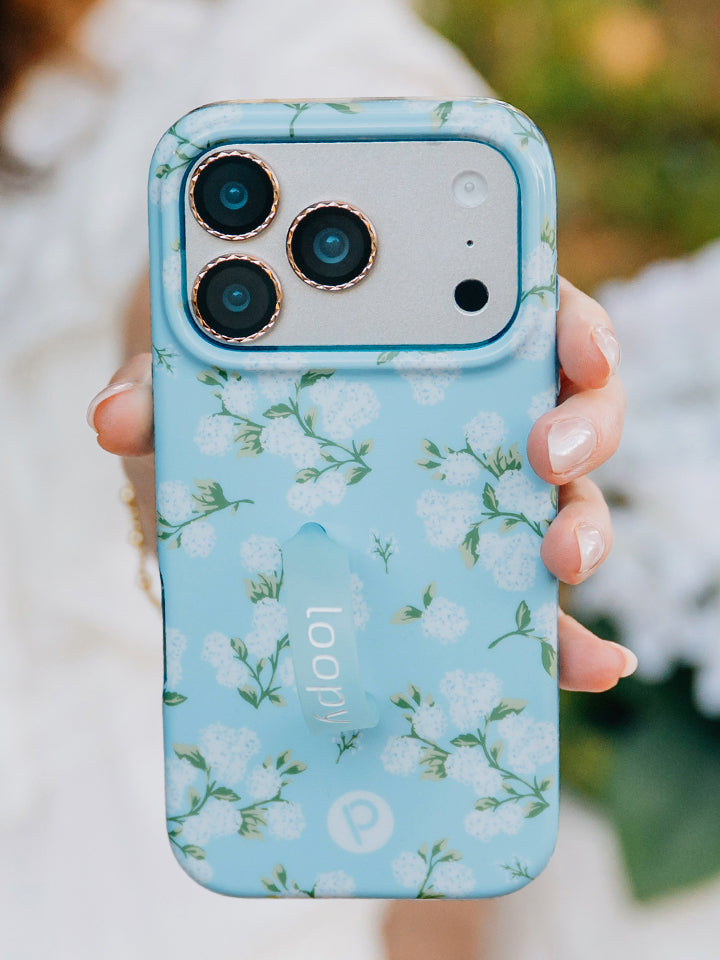 A woman holding a Hydrangeas Loopy Case. || feature-media