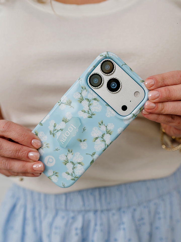 A woman holding a Hydrangeas Loopy Case. || feature-media