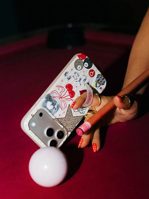 A woman holding a Lucky Girl Club Loopy Case. || feature-media