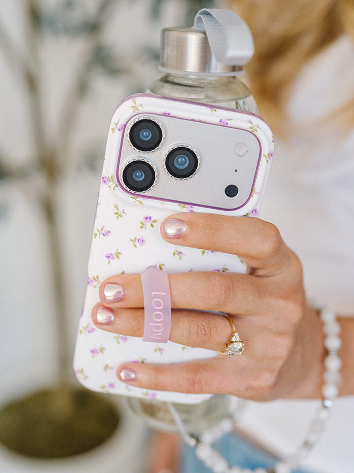 A woman holding a Lilac Fields Loopy Case. || feature-media