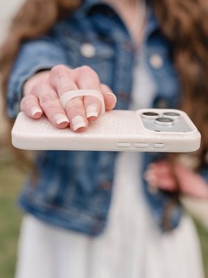 A woman holding a Lovely Lace Loopy Case. || feature-media