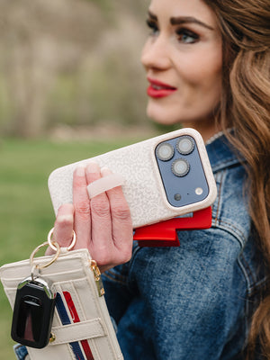 A woman holding a Lovely Lace Loopy Case. || feature-media