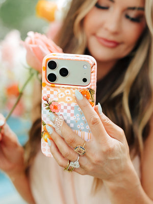 Amber Massey holding an Orange Blossom Loopy Case. || feature-media