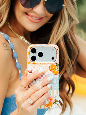 Amber Massey holding an Orange Blossom Loopy Case. || feature-media
